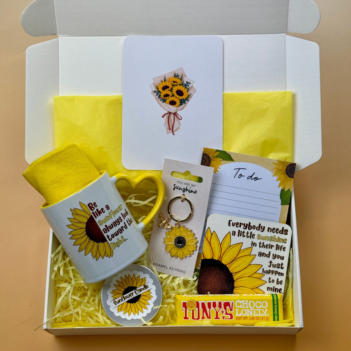 Sunflower gift box with sunflower mug, cozy yellow socks, candle, keyring, coaster, notepad, greeting card and Tony's Chocolonely chocolate