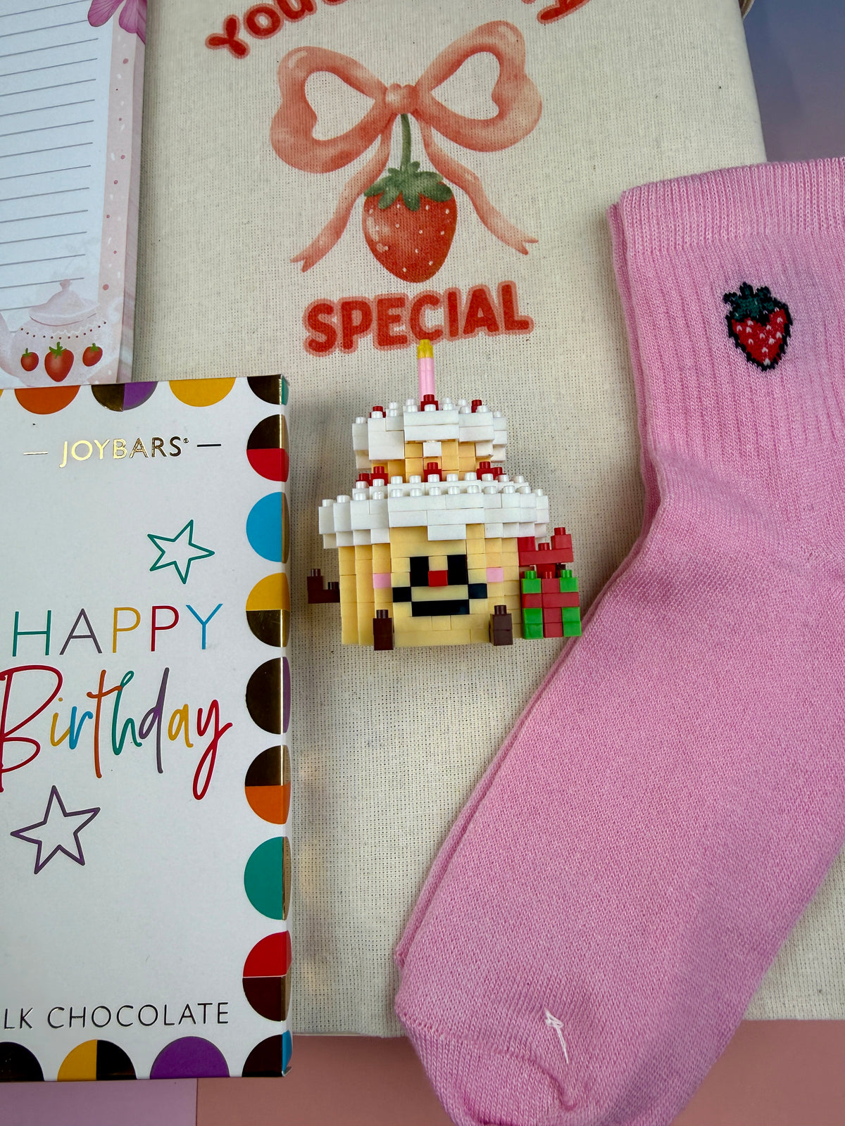 Natural cotton tote bag with You Are Berry Special strawberry and pink bow illustration Pink strawberry embroidered socks and DIY miniature birthday cake building block kit in a cute gift set