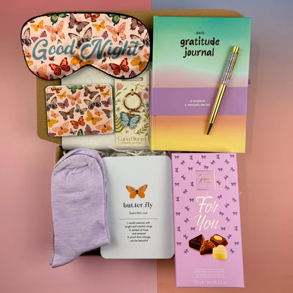 Butterfly self-care gift box with gratitude journal, butterfly note card, butterfly card holder, sleep mask, enamel keyring, lilac cherry socks, amethyst pen and Belgian chocolates