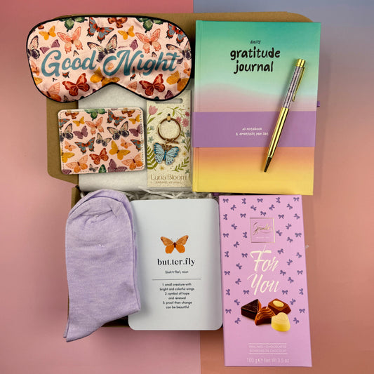 Butterfly self-care gift box with gratitude journal, butterfly note card, butterfly card holder, sleep mask, enamel keyring, lilac cherry socks, amethyst pen and Belgian chocolates