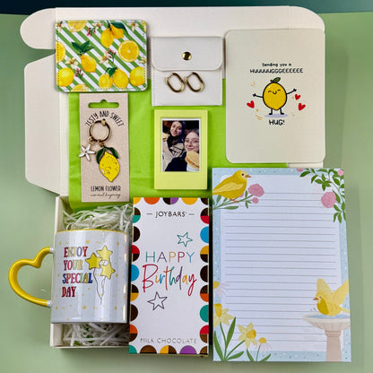 Personalized birthday gift box with mug, lemon card holder, keyring, photo frame, earrings, chocolate and stationery
 Copy